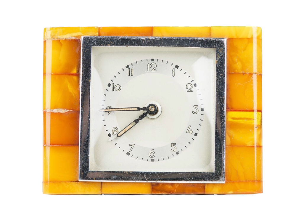Amber-cased table clock with silver-set dial, in the inter-war Königsberg amber-and-metal idiom.